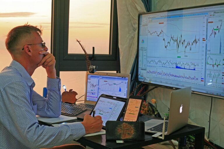Male analysing forex trading charts with all devices